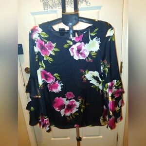 Floral print pullover blouse with one back button. Layered long bell sleeves.